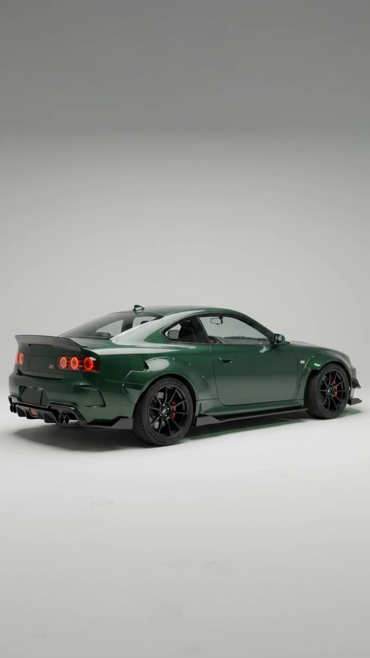 A 10-second studio car video: the camera circles a green widebody coupe, the door opens and the shot moves inside to the seats, gauges and gear lever.