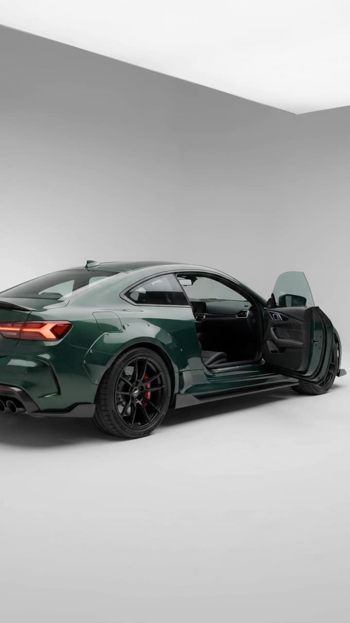 A 10-second studio walkaround of a green coupe: the door closes, the headlight switches on in close-up, then the camera pulls back to the full profile.