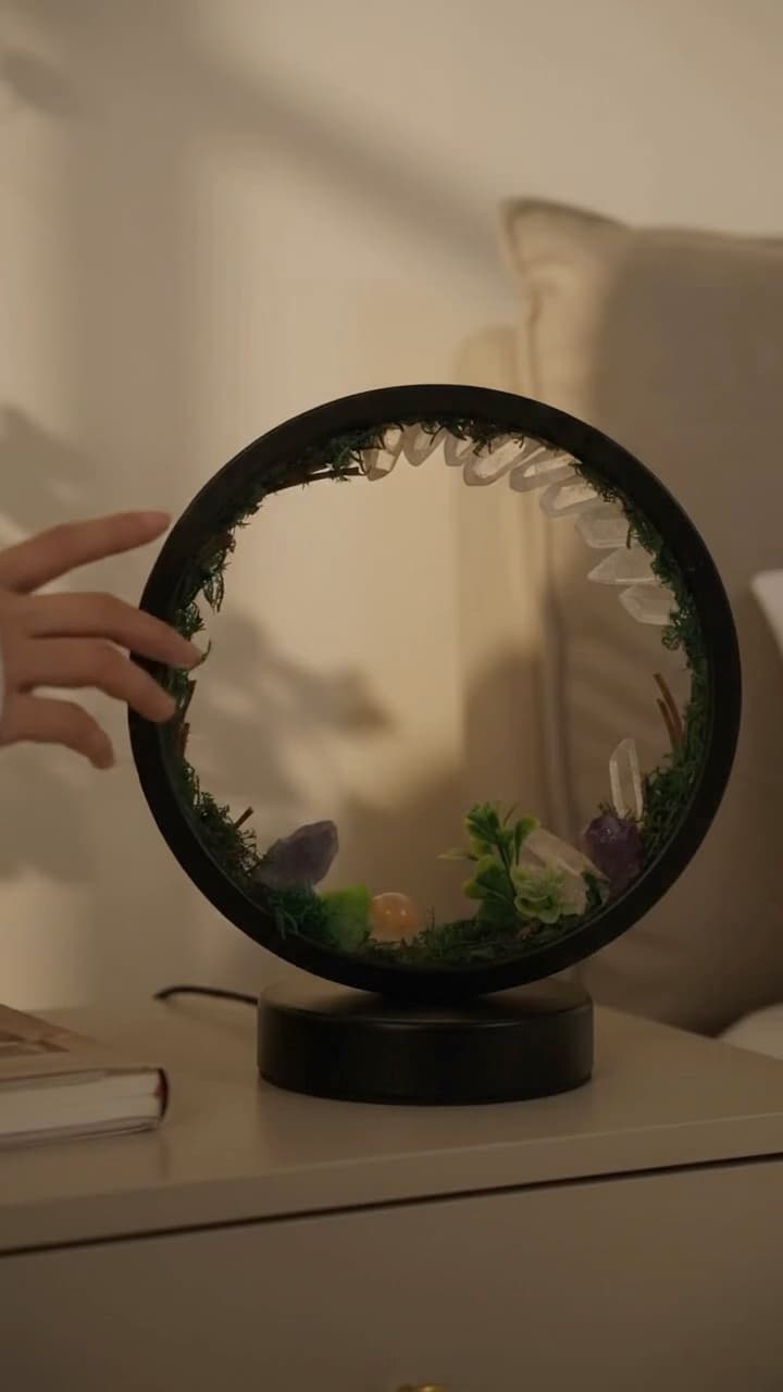 A 10-second lifestyle video for a moss and crystal ring lamp: on a nightstand in the morning, a desk with a laptop and tea, and a sofa table at night.